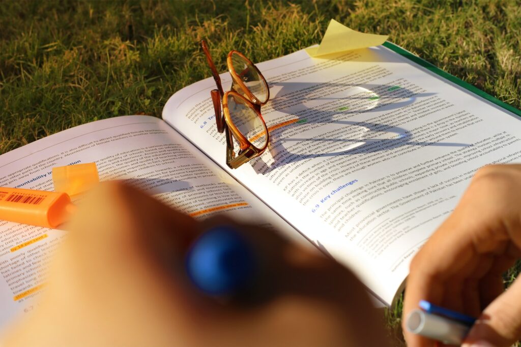 brown framed sunglasses on book page